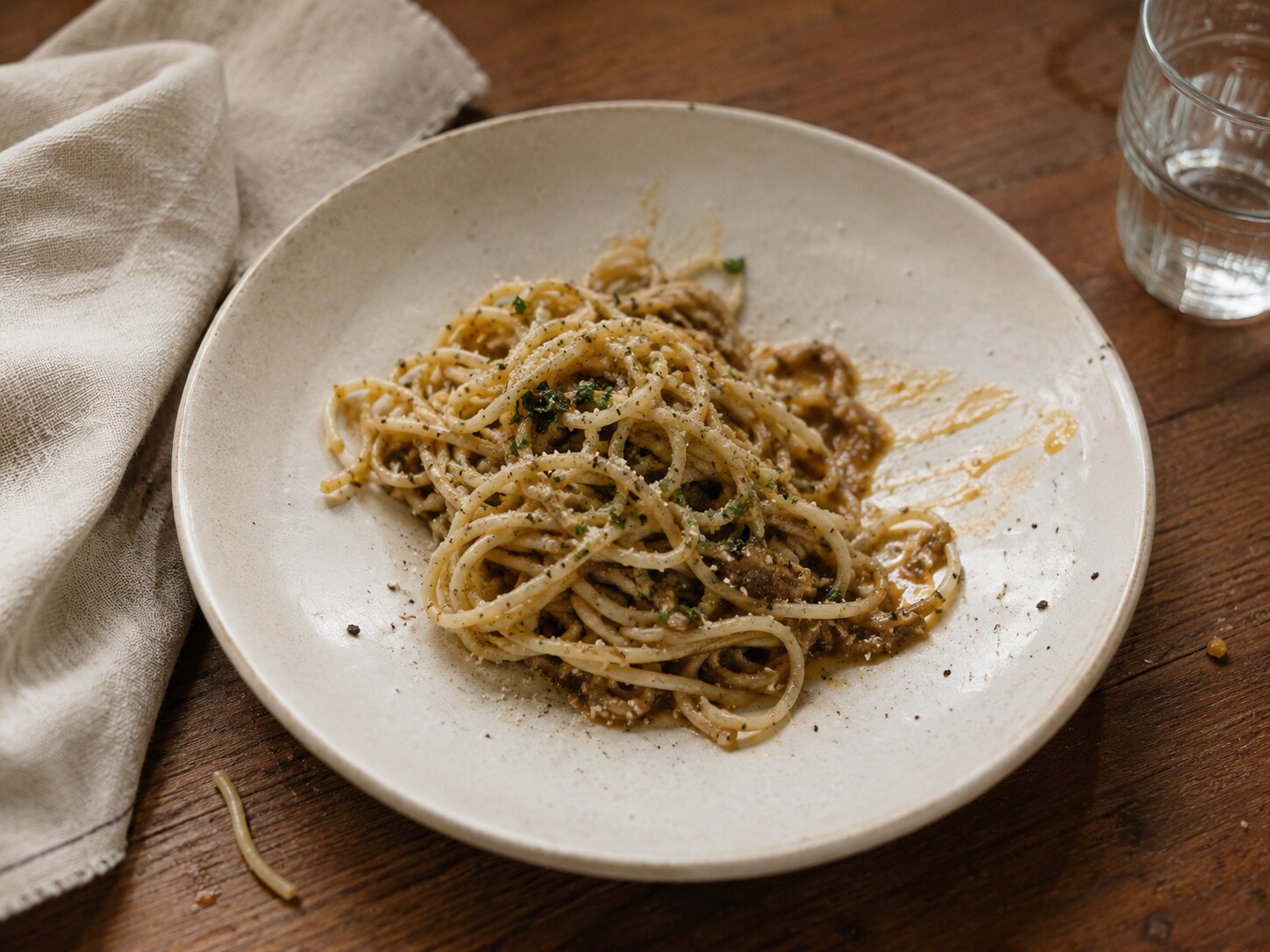 A plate of pasta in natural light, imperfect honest plating